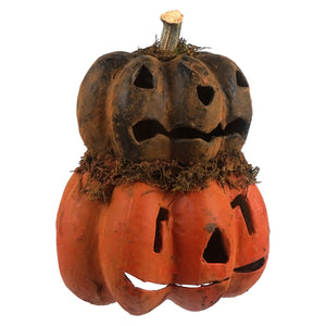 Orange and black tabletop decor featuring a black two layered carved pumpkin with weathered mossy stem jack o lantern faces
