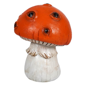 Orange mushroom figurine with creepy painted eyes and a textured weathered finish in orange and white