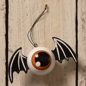White ceramic eyeball bat ornament with dramatic black-and-white wings and orange details by bethany lowe designs
