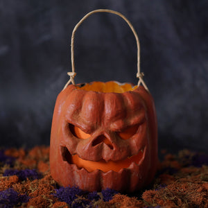 Orange scary face pumpkin bucket with raggedy junction design and woven handle handcrafted folk art lantern
