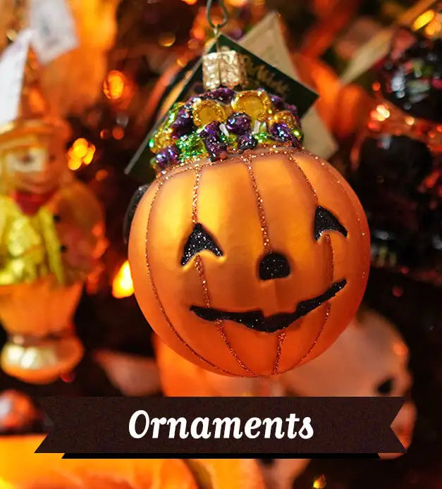 A display featuring a pumpkin ornament hanging on a tree with a banner that reads "Halloween Ornaments"