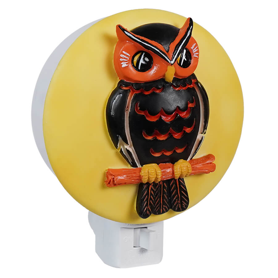 Decorative owl-shaped night light with a yellow circular background.