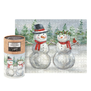 A snow family puzzle box with a burlap lid featuring two snowmen in red scarves in a vintage santas puzzle style