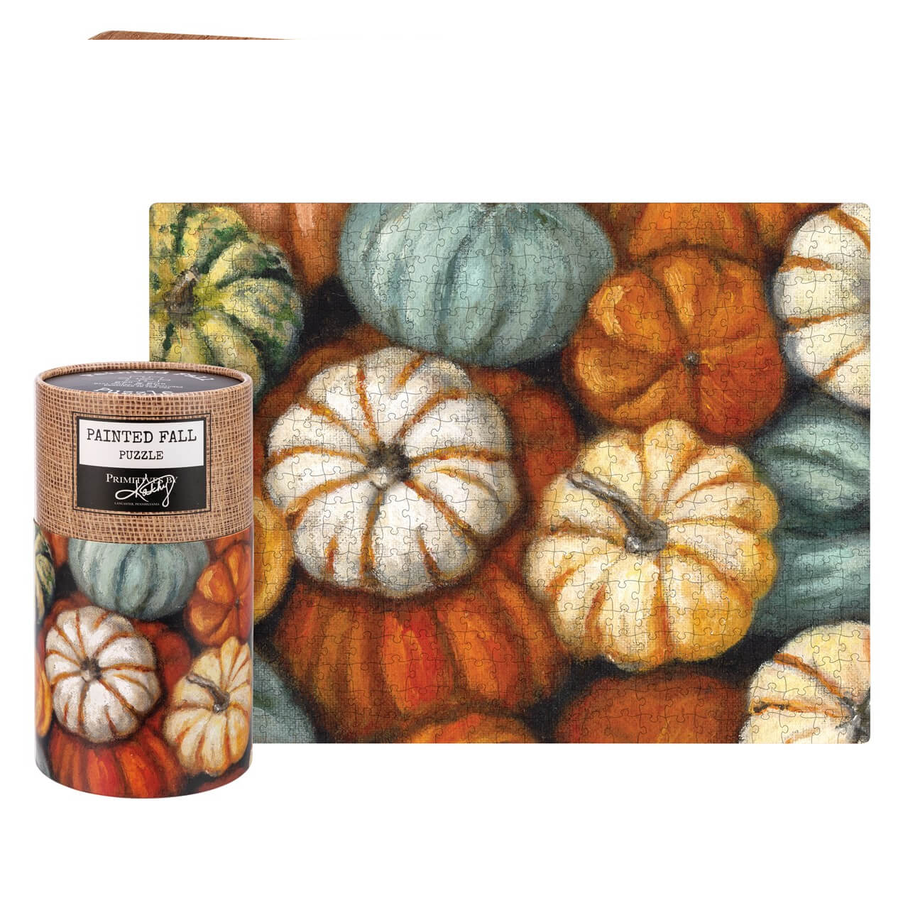 A cylindrical puzzle box with burlap wrap featuring the painted fall 1000 piece pumpkin puzzle with colorful pumpkin designs