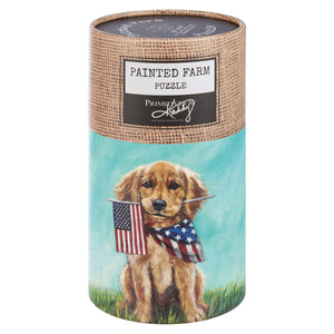 Cylindrical puzzle container featuring artwork of a patriotic puppy holding an American flag and wearing a stars-and-stripes bandana.