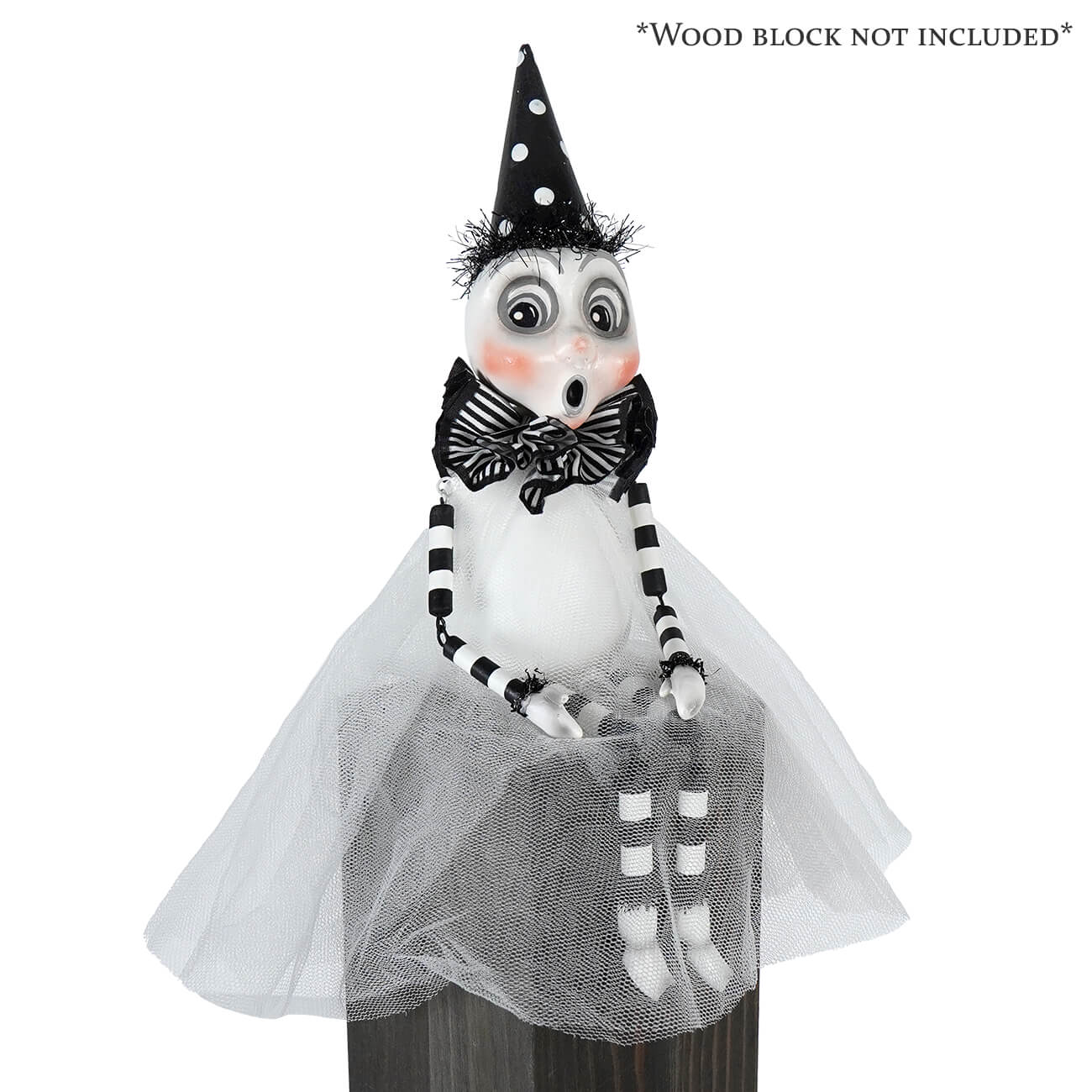 A whimsical black and white party ghost sitter witch figurine with polka dot hat striped bow tie and tulle skirt ghost decor