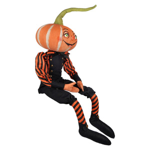 A cheerful pascal pumpkin doll from joe spencer’s gathered with an orange pumpkin head and striped shirt and socks