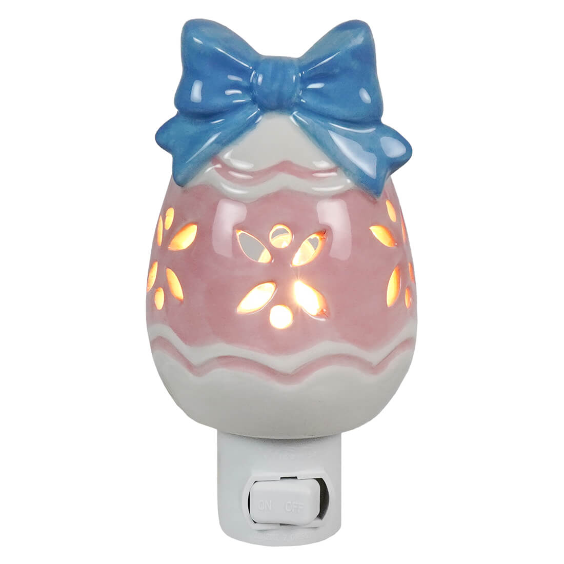 Pastel colored easter egg night light made of pink and white ceramic with a blue bow perfect for easter lighted decor