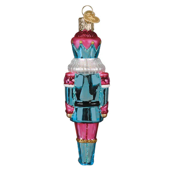 Pastel nutcracker ornament in vibrant blue and pink glass with glittery accents and silver trim perfect for figural decor