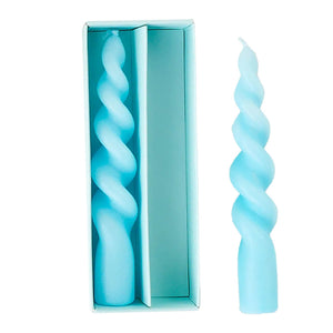 A pair of light blue twisted pastel swirl candles with one in a box perfect for easter decor and gifts