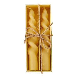 Two golden honey-colored twisted beeswax candles in a pastel swirl candles box set tied with twine perfect for easter decor