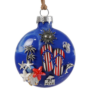 Patriotic beach day blue ornament with blue glass and silver and red charms featuring palm trees and flip flops