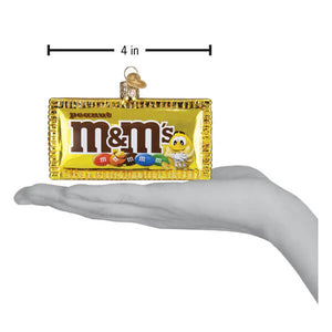 Golden glass peanut m&m’s ornament shaped like a candy bar wrapper with colorful m&m’s and iconic logo