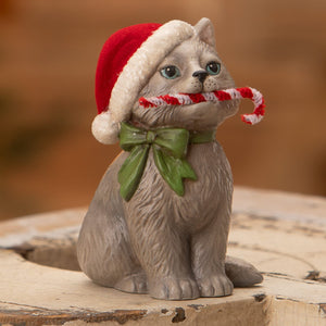 Gray ceramic kitty figurine with red white santa hat and green bow holding candy cane by bethany lowe design