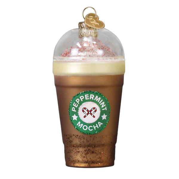 A clear glass peppermint mocha ornament with gold rim and pink sprinkle whipped coffee ornament for tabletop decor