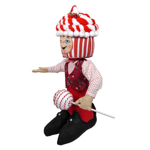 Peppermint paul standing doll wearing a red and white striped candy outfit with pom-pom hat and black shoes