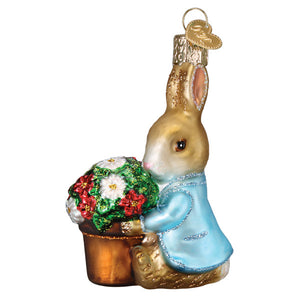 Golden glass peter rabbit ornament wearing light blue coat holding potted red and white flowers figural decor