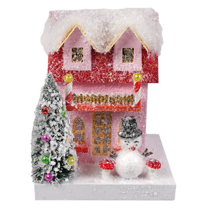 Petite pink snowman cottage by cody foster featuring a glittery pink and red house with snowman and candy cane pillars