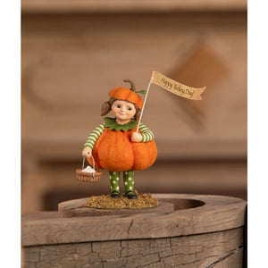 A charming petunia pumpkin pie figurine by bethany lowe dressed in green and white stripes holding a happy turkey day flag