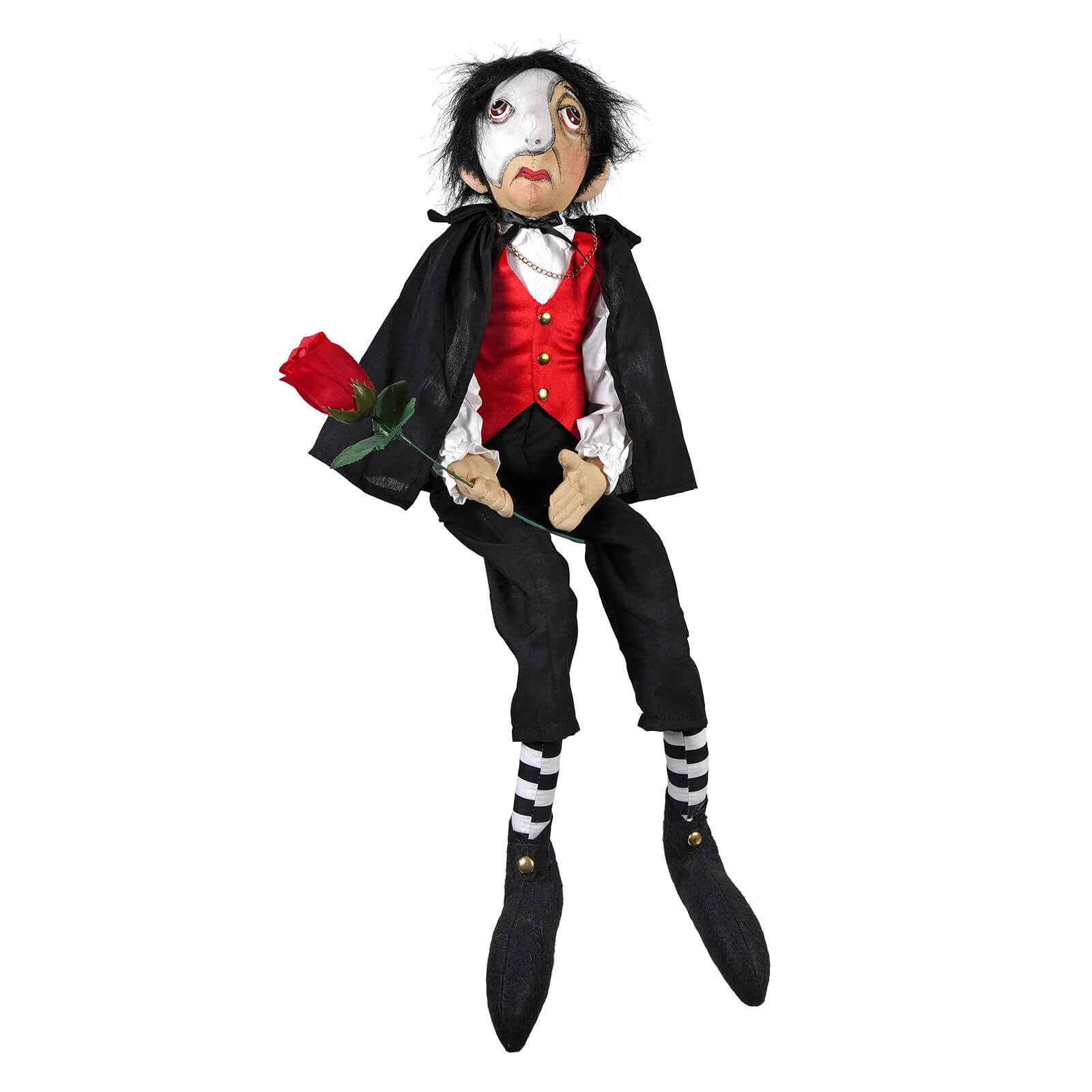 A black and white painted phantom phillip doll wearing a red vest and black cape holding a red rose by joe spencers gathered traditions
