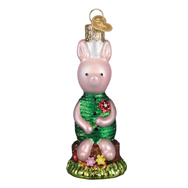 Pink glass piglet ornament wearing green sequined dress with red flower brooch sitting on floral tree stump base christmas glass ornament