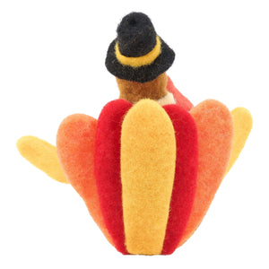A felt pilgrim turkey critter from kathys pilgrim turkey harvest collection with a black hat and red orange fabric stripes
