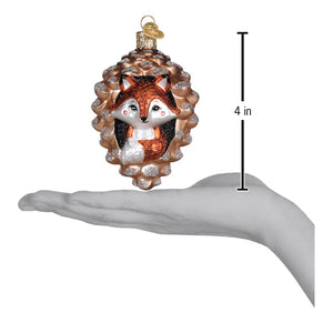 A charming piney fox ornament with a glittery orange and white fox inside a glass pinecone figural decor for trees