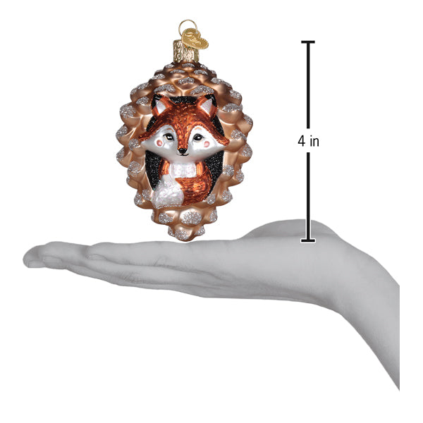 A charming piney fox ornament with a glittery orange and white fox inside a glass pinecone figural decor for trees