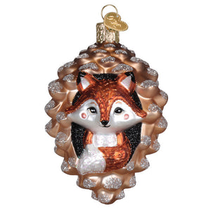 A charming glass piney fox ornament with a cute fox in a pinecone featuring silver and copper tones figural decor