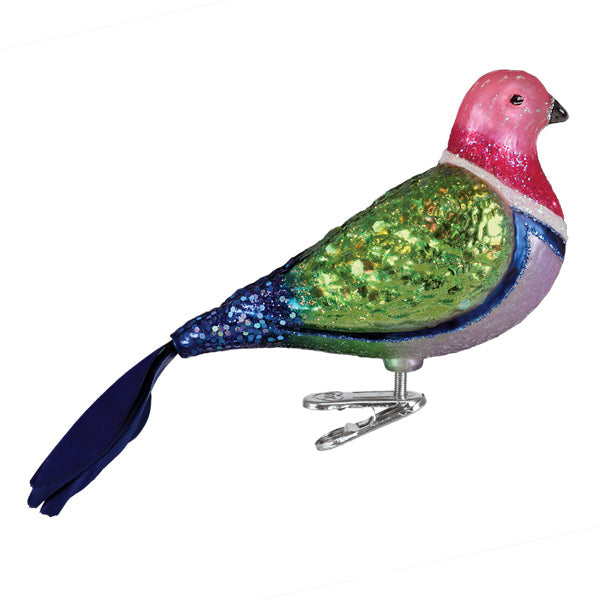 A vibrant pink fruit dove ornament made of glittery glass with green and blue figural decor for tree toppers