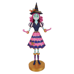 Pink itchy witchy tabletop figurine with pink curly hair navy hat and polka dot dress perfect for halloween witches decor