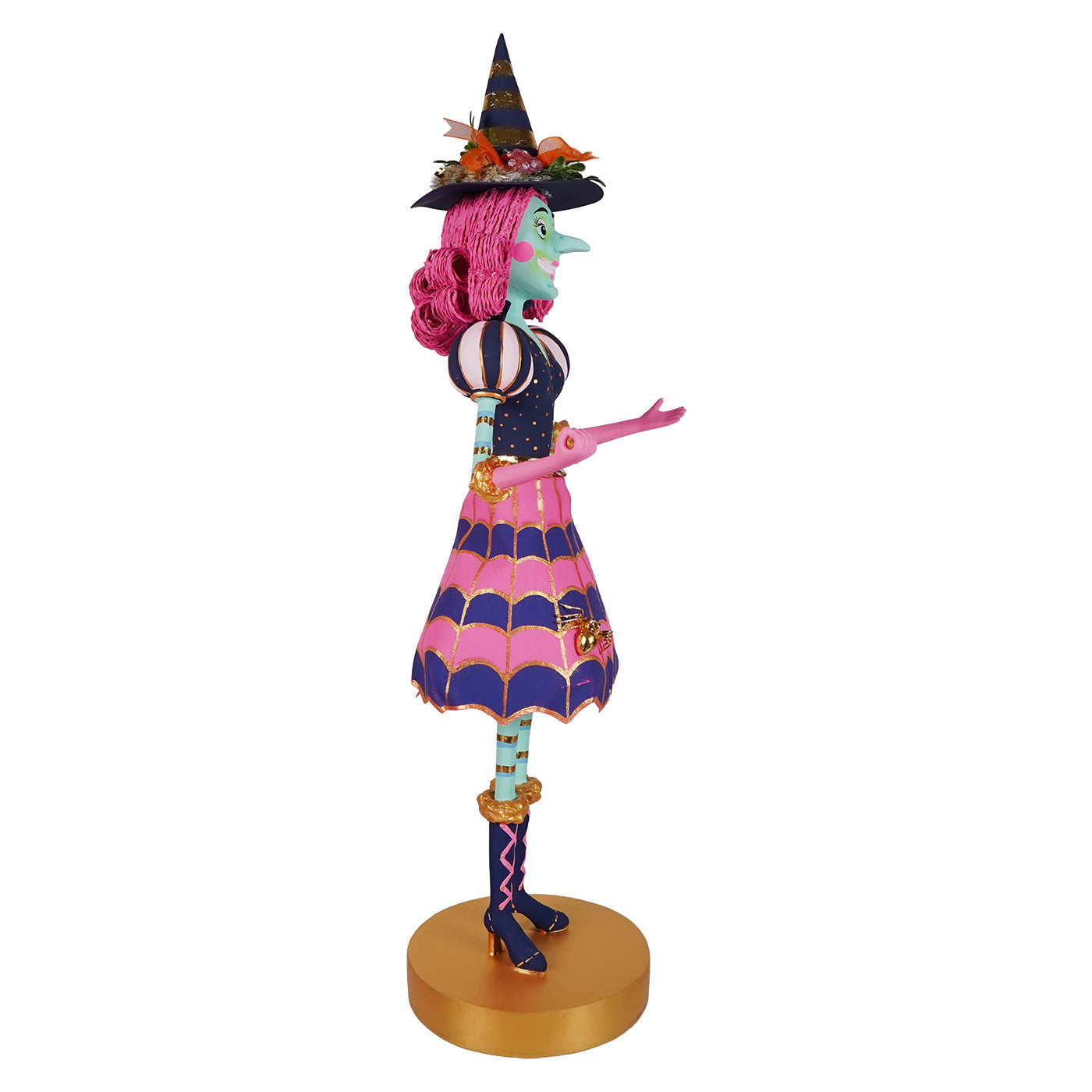 A whimsical itchy witchy figurine with vibrant pink hair and colorful witch decor perfect for halloween witches fans