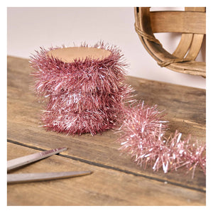 A roll of shimmering rose gold pink tinsel garland with a fuzzy texture perfect for easter and spring garlands