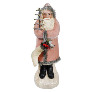 Vintage velvet belsnickle santa figurine in soft pink coat with tinsel trim holding decorated christmas tree branch