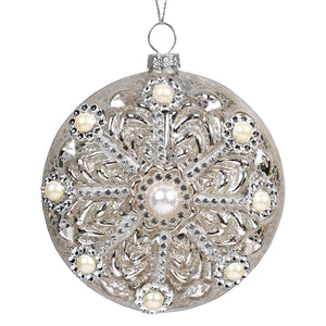 Silver ornamental christmas bauble with intricate filigree, embedded pearls, rhinestones on gold glass gilded pearl disc