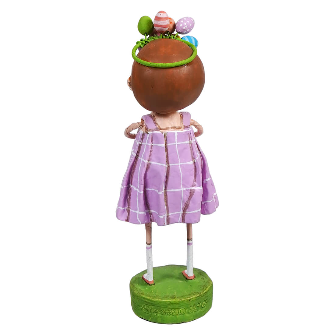 Decorative figurine wearing a lavender dress and floral headpiece standing on a green base.