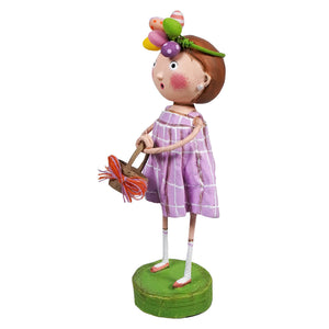 Whimsical decorative figurine of a girl in a purple dress holding a butterfly, standing on a green base.