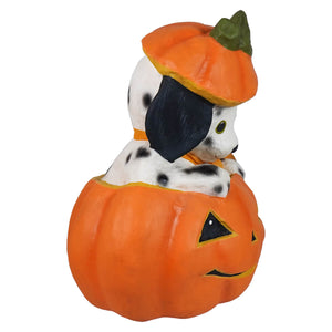 Poppy puppy figurine wearing an orange pumpkin hat inside a carved halloween pumpkin with black eyes and smile