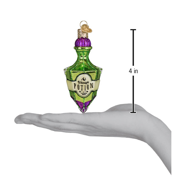 A green and purple glass potion bottle ornament with a gold cap labeled witchcraft potion by old world christmas, perfect halloween cauldron ornament and tabletop decor