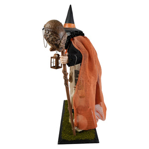 Potion peddler zelda witch figurine with black hat orange cape and lantern on mossy base halloween witches decor