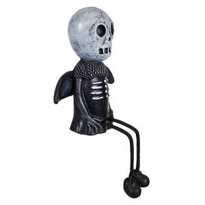 Whimsical black and silver primitive skull shelf sitter with winged arms, rope scarf, and braided legs for shelves