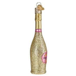 A glittery gold prosecco bottle ornament with a pink label and heart tag perfect as a christmas glass ornament