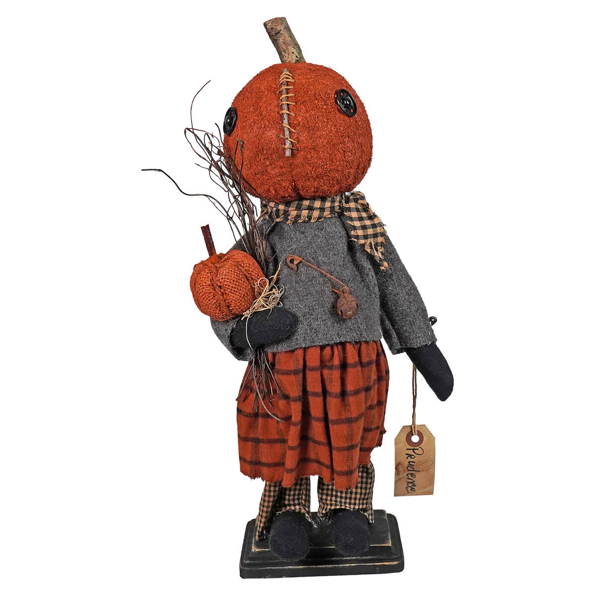 Decorative pumpkin-headed doll figure in autumn-themed clothing holding a small pumpkin.