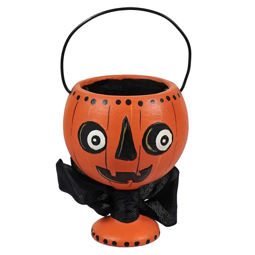 Halloween-themed pumpkin candy bucket with a face and black bow.