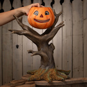 Pumpkin hollow hideaway orange pumpkin figural decor with smiling face on dark brown tree trunk base by bethany lowe designs happy haunting tree