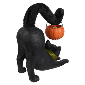 Black cat figurine with plush tail holding orange pumpkin candy bucket perfect for vintage halloween tabletop decor and halloween cats