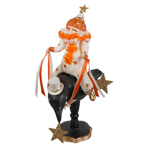 Pumpkinhead on crow features a jack o lantern clown in orange ruffles riding a black crow with gold ribbons and a top hat