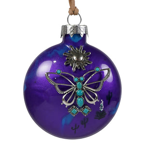 Purple desert butterfly ornament features a purple glass butterfly ornament with silver, turquoise stones, and cactus designs