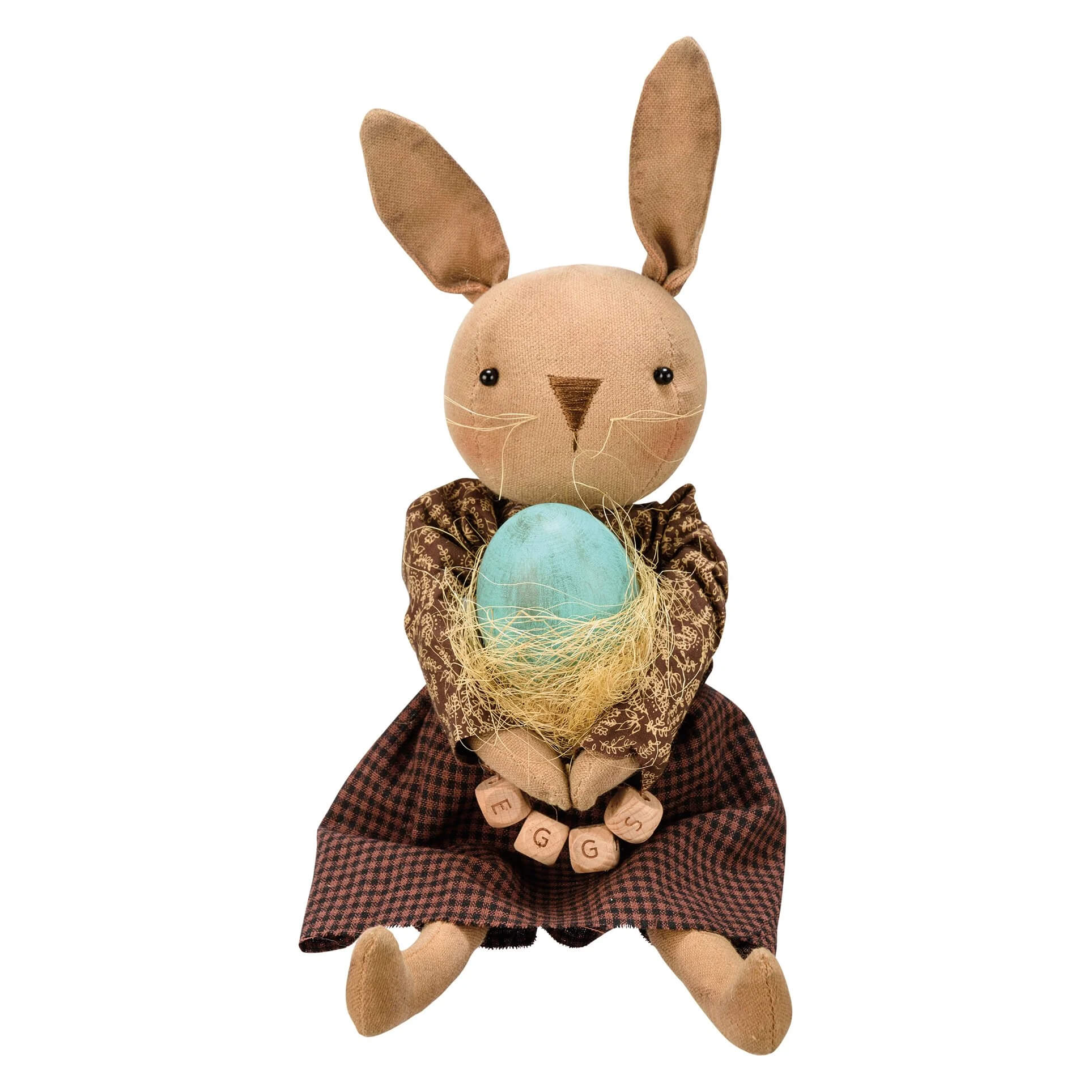 A tan fabric rabbit egg doll wearing a brown checkered dress holding a light blue egg in yellow yarn nest