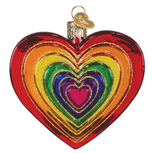 A vibrant rainbow heart ornament made of glass with glittered gold edges and a colorful pink glittered heart design